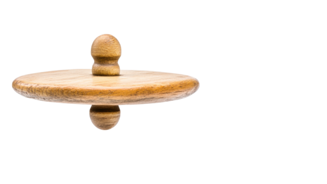 Spinning wooden top on a black background.