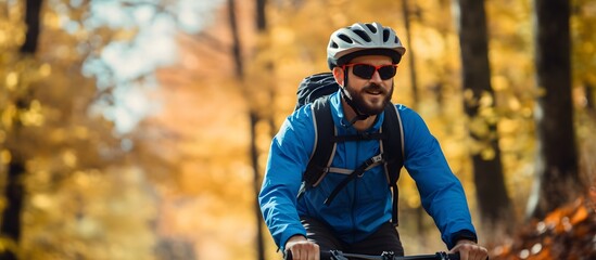Happy man on a mountain bike on a trail in the woods