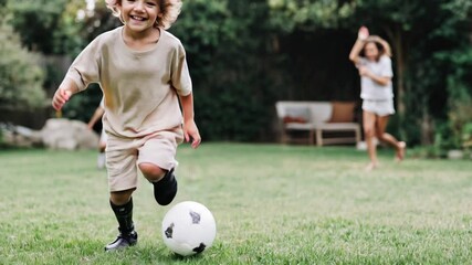Young child with a prosthetic leg playing soccer in a backyard with friends. Inclusive play, adaptive sports, and joyful childhood moments. - Powered by Adobe