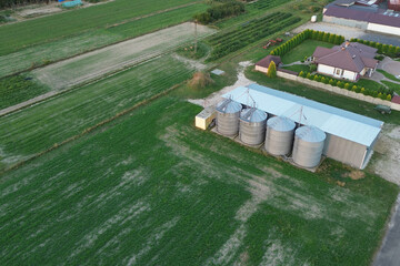 Rural landscape with house and grain silos
