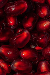 close up of red pomegranate arils, seeds
