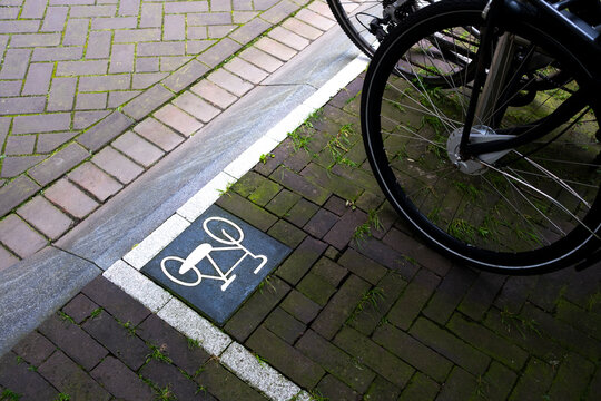 A marked bicycle parking space on a sidewalk highlights urban planning and cycling infrastructure in modern cities and promotes eco-friendly transportation options in Amsterdam Zuid