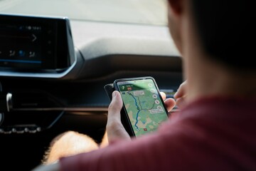 Man checking a map on google maps on his smartphone while travelling through Portugal on holiday