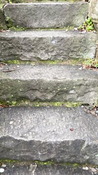 Climbing stone steps on mountain. Ancient construction. Traditional buildings in Italy, Liguria. Municipality of Monella near Mediterranean Sea. 