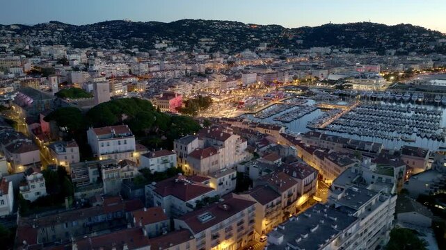 night illumination in Cannes aerial view, famous resort on the French Riviera, the city of Cannes film festival, Cannes harbour with luxury yachts from a drone