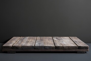 Rustic wooden platform against dark wall, product display