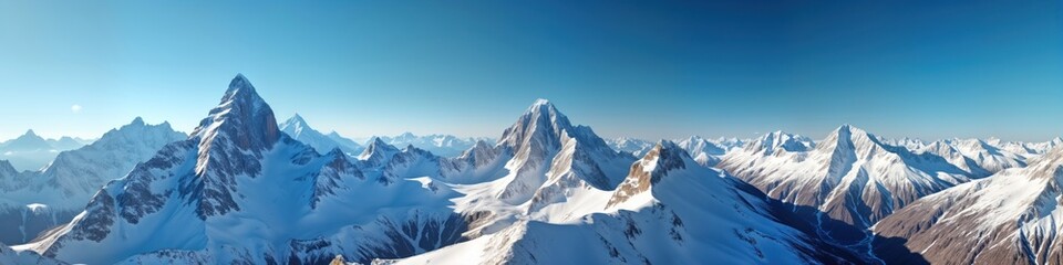 Obraz premium Panoramic view of snow-capped mountain peaks under bright sunlight. Majestic mountain range stretches far into distance. Snowy peaks, ridges create stunning landscape. Alpine scenery shows rugged