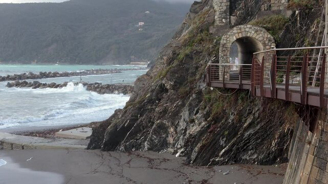 Old tower near sea in storm on mountain. Overcast weather, fog. Old building in Italy. Municipality Moneglia, Liguria region. 