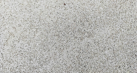 A close-up of a porous aerated concrete surface with fine texture