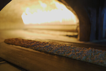 Long pita or pita bread baked in an oven or on a stove in a restaurant. Concept image of a bakery or pastry shop.