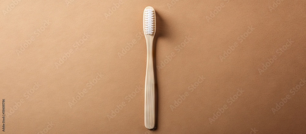 Aufkleber bamboo toothbrush featuring a white handle set against a brown craft paper background in a flat lay 
