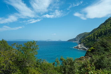 View of the sea, mountains, rocks, beaches, islands and the sky from different sides of the Skopelos island Greece.