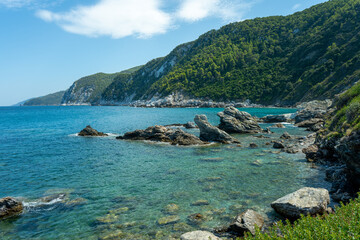 View of the sea, mountains, rocks, beaches, islands and the sky from different sides of the Skopelos island Greece.