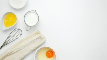 Baking Crinkle Cake, near baking dish with ingredients, phyllo dough, egg, butter, nuts, milk