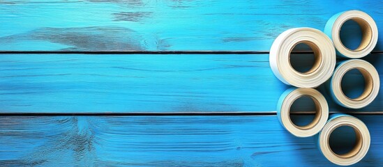 Rolls of adhesive tape on a blue wooden surface. with copy space image. Place for adding text or design