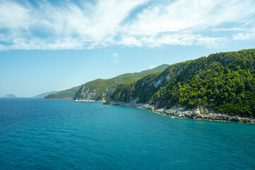 View of the sea, mountains, rocks, beaches, islands and the sky from different sides of the Skopelos island Greece.