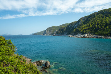 View of the sea, mountains, rocks, beaches, islands and the sky from different sides of the Skopelos island Greece.