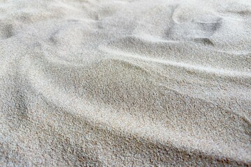 Golden Sand Texture Nature Close-up of attractive golden sand, showing the naturally curved surface and fine sand grains. This image focuses on the interaction of light and shadow. Nature,
