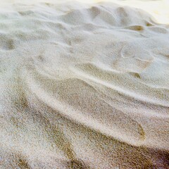 Golden Sand Texture Nature Close-up of attractive golden sand, showing the naturally curved surface and fine sand grains. This image focuses on the interaction of light and shadow. Nature, © Kitichai