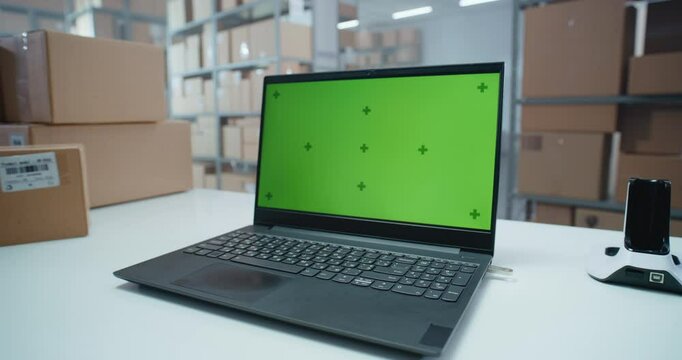 Postal Warehouse Associate Scans Code on Cardboard Box with Barcode Scanner, Checks Parcel Information, Tracks Package Delivery Route. Laptop Computer Screen Shows Green Screen Chroma Key. Close Up.