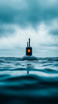 A close up of a submarines periscope breaking through the surface of a calm sea with ripples spreading outward under a cloudy sky 