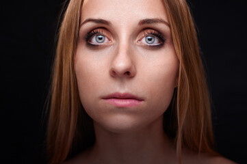 Fototapeta premium Close-Up Portrait Photograph of a Woman with Bright Blue Eyes and Fair Hair..