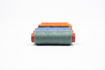 Set of different colorful sewing threads on white background
