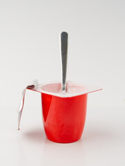 Yogurt cup isolated, pink fruit yoghurt in plastic pot, milk pudding container, dairy food