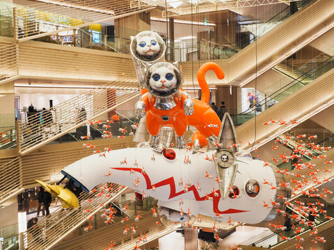 TOKYO, JAPAN - January 10, 2025: A pair of large models of a cats and many smaller ones in Ginza Six shopping mall. They're part of the installation 'Big Cat Bang' by Kenji Yanobe.