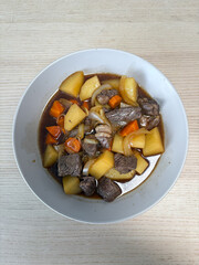 A plate of beef and potato stew.