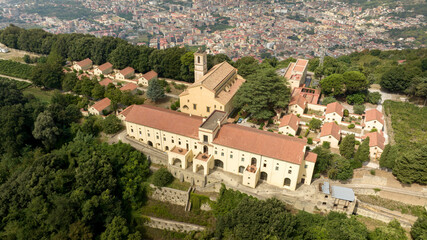 Obraz premium Aerial view of the Eremo dei Camaldoli in Naples, Italy. It's a ancient religious complex with a Catholic church and is located on top of a mountain. The hermitage overlooks the city in the background