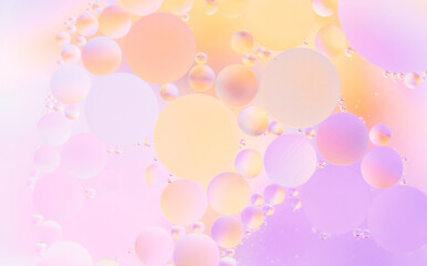 Beautiful cosmetic background. Golden yellow orange abstract oil bubbles or face serum background.