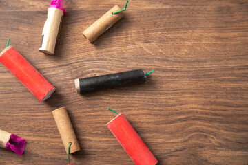 Firecrackers on the wooden background.