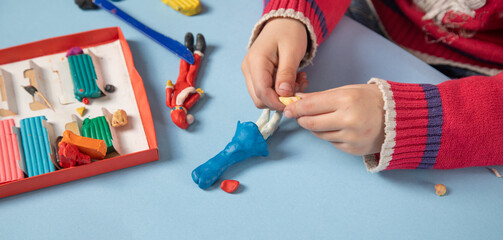 Little child playing plasticine. Hobby