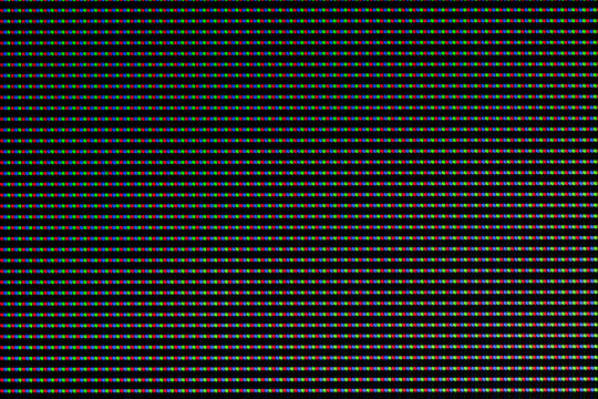 Red, green and blue LEDs on a TV screen close-up. Background of RGB lamps on the screen