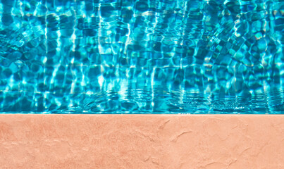 Obraz na płótnie Canvas Water texture background,Pool edge with water wave pattern with sunlight reflection on floor for product in summer background,Top view swimming pool with blue water and brown floor brown floor