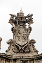 Papal coat of arms on St. Peter's Colonnade in the Vatican, Italy