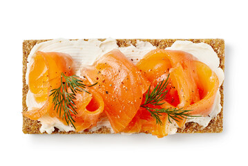 Crispbread with salted salmon slices and cream cheese isolated on white background