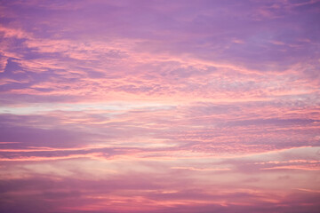 Sunset in the sky in pastel colors. Purple and pink sky with clouds in the evening. Nature background.

