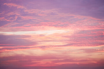 Fototapeta premium Sunset in the sky in pastel colors. Purple and pink sky with clouds in the evening. Nature background. 