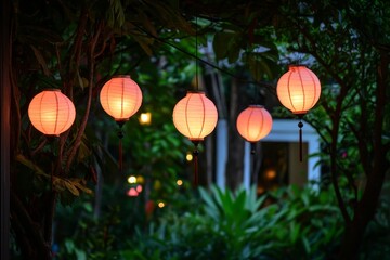 Obraz premium Elegant Pink Paper Lanterns Hang Gracefully Amidst Lush Greenery, Creating a Serene Atmosphere in a Tranquil Outdoor Space at Dusk with Soft Lighting