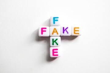 Obraz premium word fake with colorful letters on white background