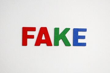 word fake with colorful letters on white background