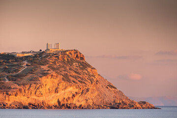 Cape Sounion and Temple of Poseidon. Beautiful sunset over Mediterranean Sea in Greece next to...