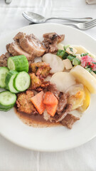 Plate presenting meat, cucumber, potatoes, and salad in sataya resort restaurant in egypt