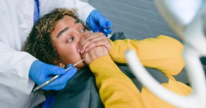 Young Black Woman with Afro Experiences Dental Anxiety During Checkup: Fear and Discomfort in the Dentist's Chair