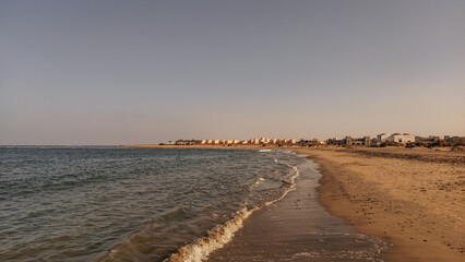 Gentle waves of red sea  washing marsa alam beach in egypt at sunset