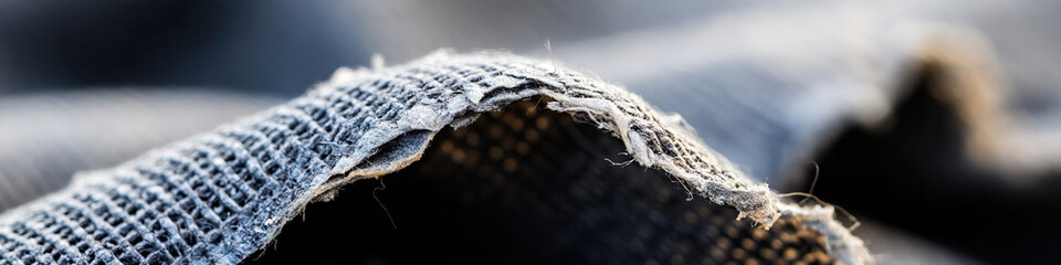 Obraz premium Close-up of Frayed Woven Fabric Showing Texture and Wear