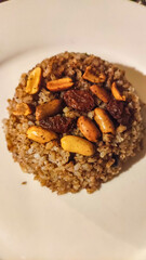 Egyptian rice dish with peanuts and raisins served on white plate in resort marsa alam, egypt