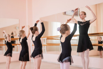 Children's ballet school. Caucasian woman teaching ballet to little girls.  © Михаил Решетников